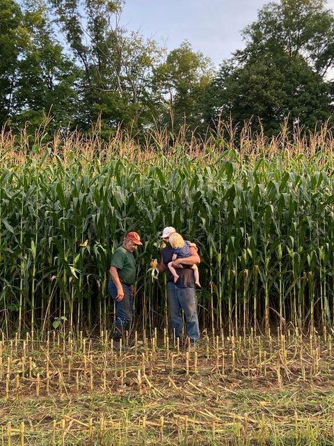 Russ and family in front of corn field