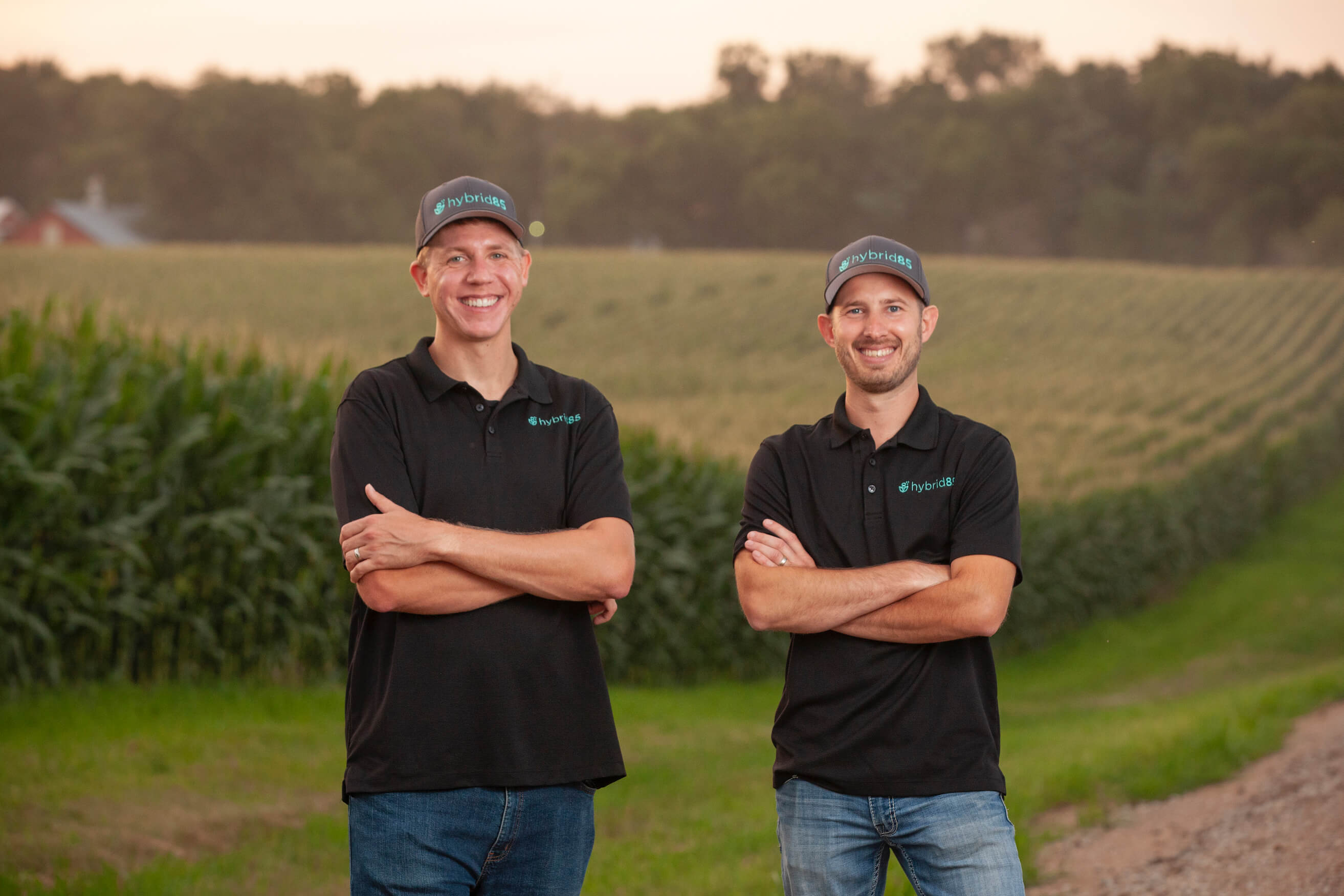Co Owners of Hybrid85 in front of corn field